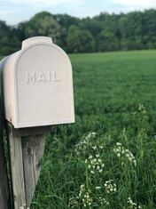 picture of a mailbox in a green field